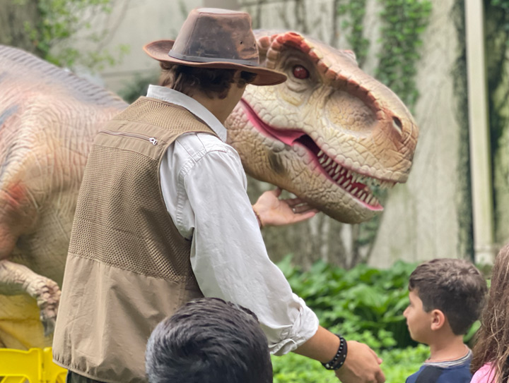 Walking dinosaur performing at library Unearth a Story event
