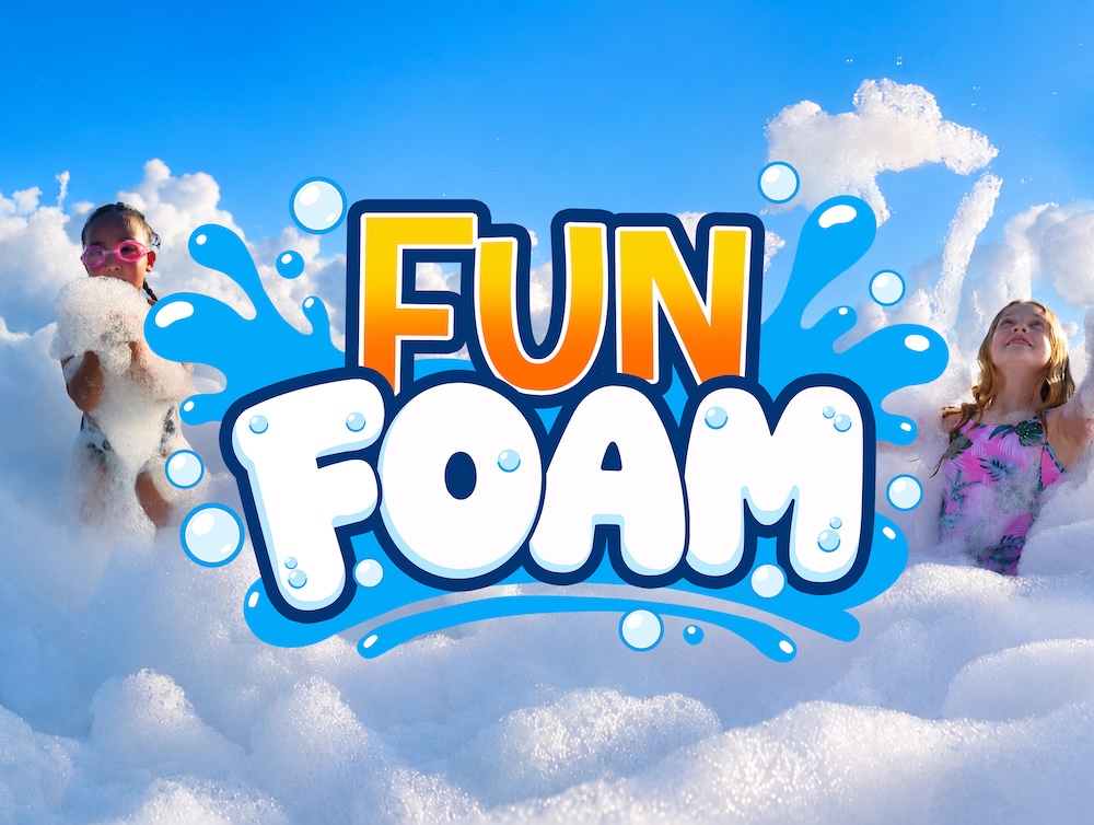 Children playing and dancing in giant foam bubbles during a Fun Foam Party birthday party in Michigan with music, beach balls, and professional entertainment.